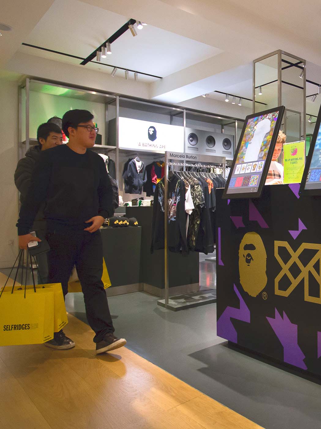 Visitors approaching the YR x A Bathing Ape booth in Selfridges department store in London.
