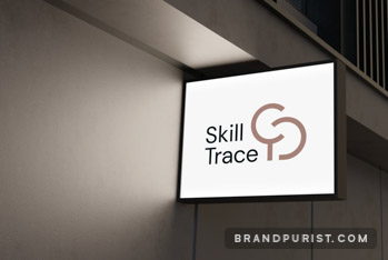 Small lightbox signage on a building’s facade at night, featuring the Skill Trace logo.