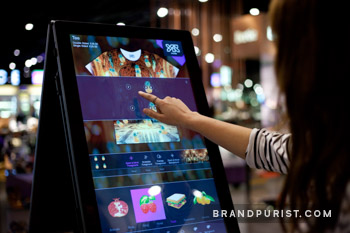 Customer actively designing a personalised t-shirt using YR Store’s interactive touchscreen.