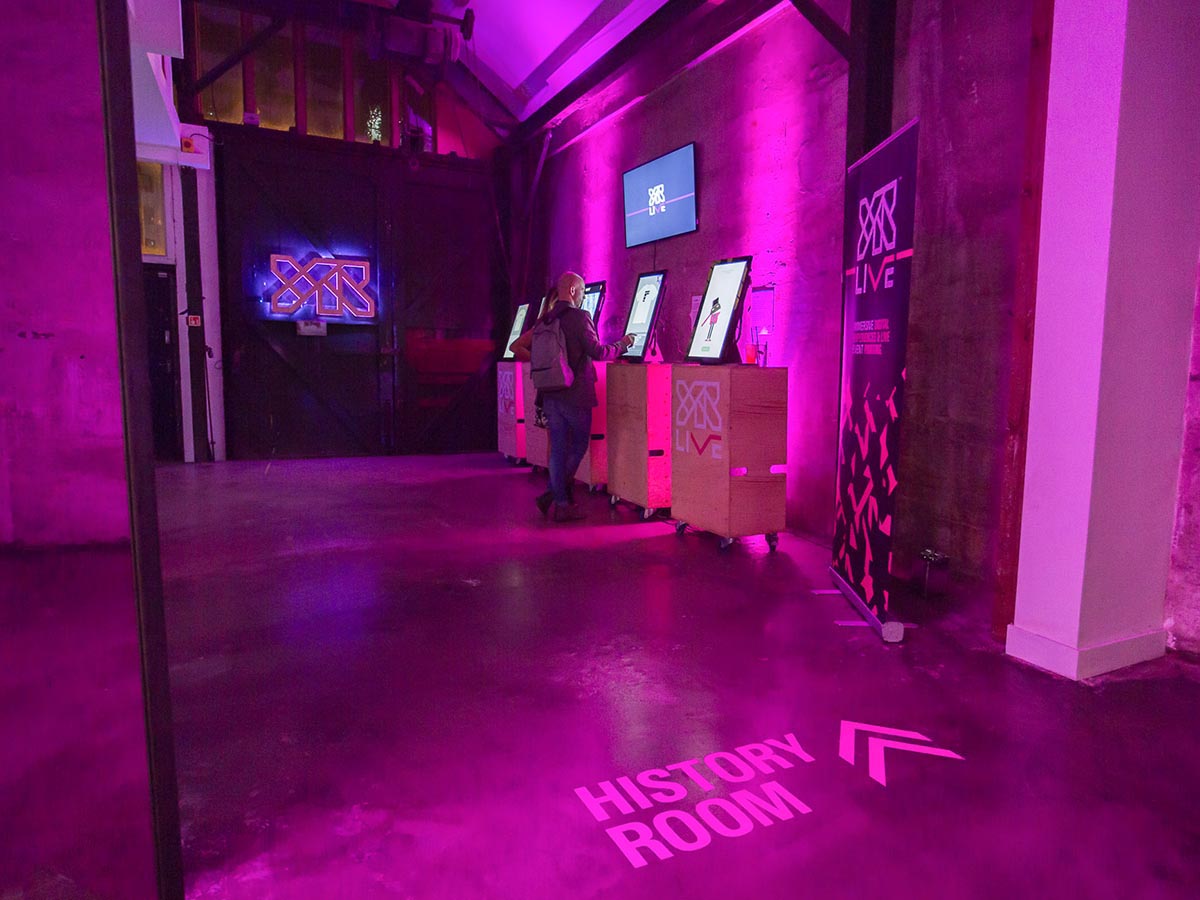 YR Live history room with past projects showcased on touchscreens at their brand launch event.