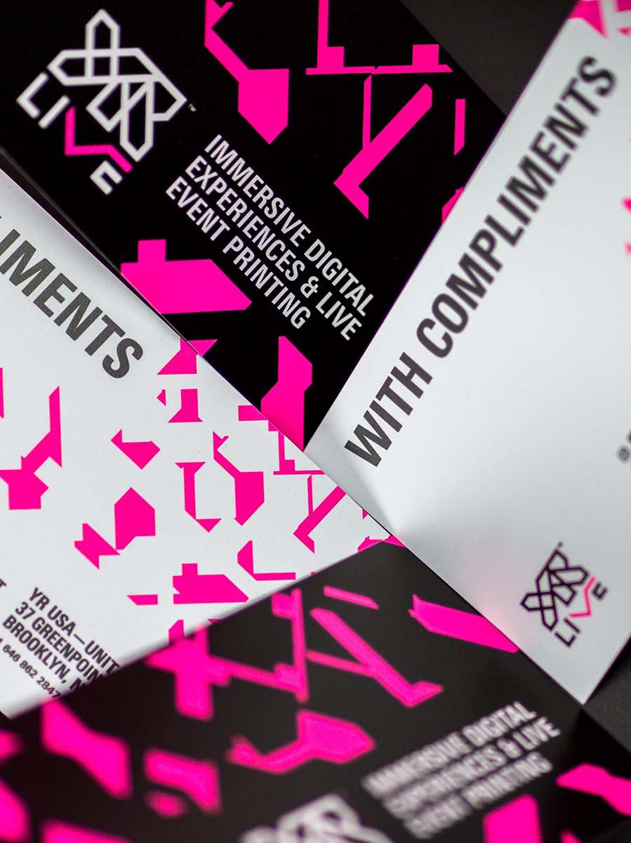 Close-up of screen printed YR Live comp slips with detailed hot pink shard patterns.