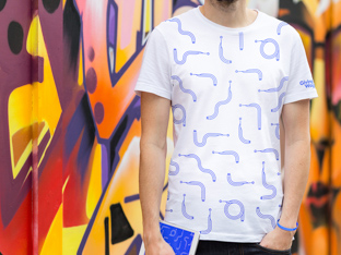 White t-shirt with blue all-over pattern on the front and GivingWays logo type on the sleeve.