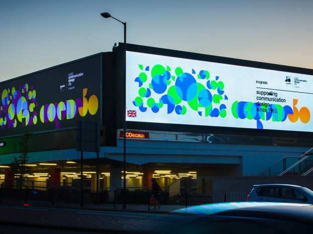 Bold, geometric designs of Icograda’s 50th anniversary displayed on JCDecaux’s advertising space along a busy London road.