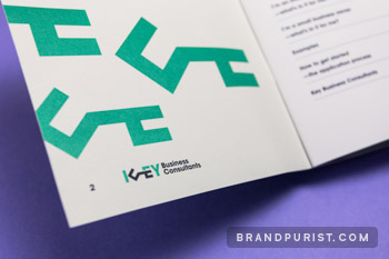 Close-up photograph of a page from Key Business Consultants’ booklet featuring the brand’s signature ‘KEY' graphics.