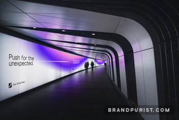 LED advertising featuring One Small Pixel branding lights a walkway tunnel.