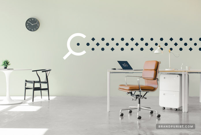 Pastel green office wall decorated with simple shapes followed by a magnifying glass graphic.