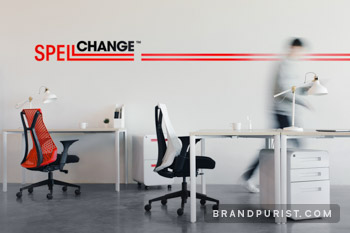 Modern office space with red and black Spell Change logo on a white wall.