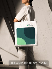 ViB Community branded canvas tote bag on the shoulder of a person. 