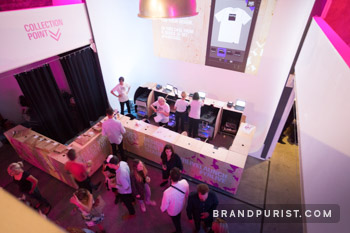 Print stations and order collection points decorated with YR Live branding. 