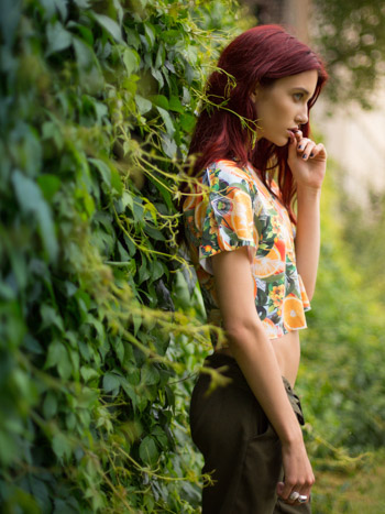 Side view of womens crop top with all-over tropical print shot for YR Store's Spring/Summer lookbook.