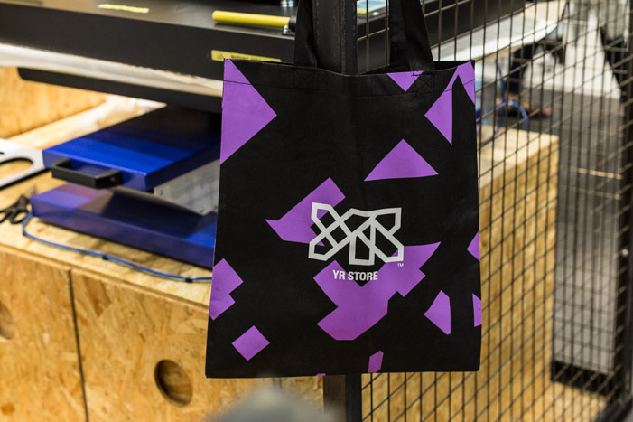 YR Store tote bag hanging in front of the heat press.